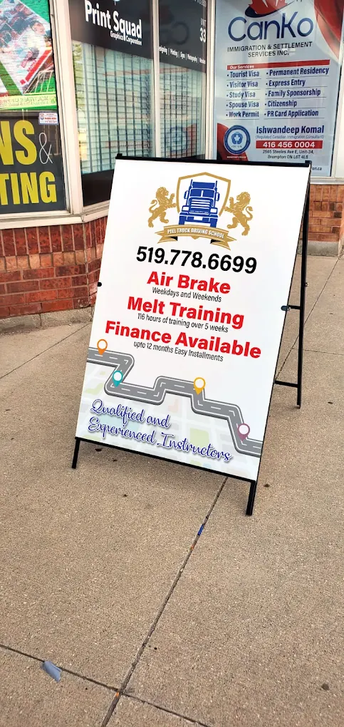 A promotional board outside Peel Truck Driving School Guelph campus displaying Air Brake and MELT training details with contact information